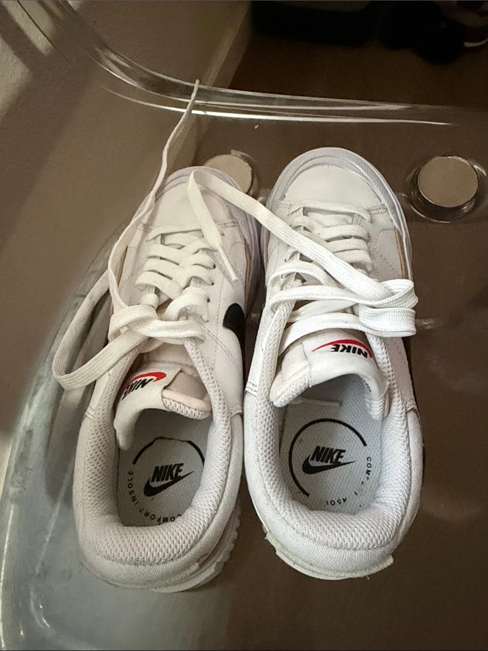 Nike White Low-Top Sneakers with Black Swoosh and Tan Accent